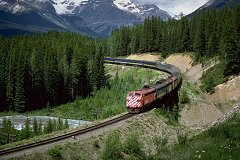 Modern diesel locomotive pulling train near Banff
